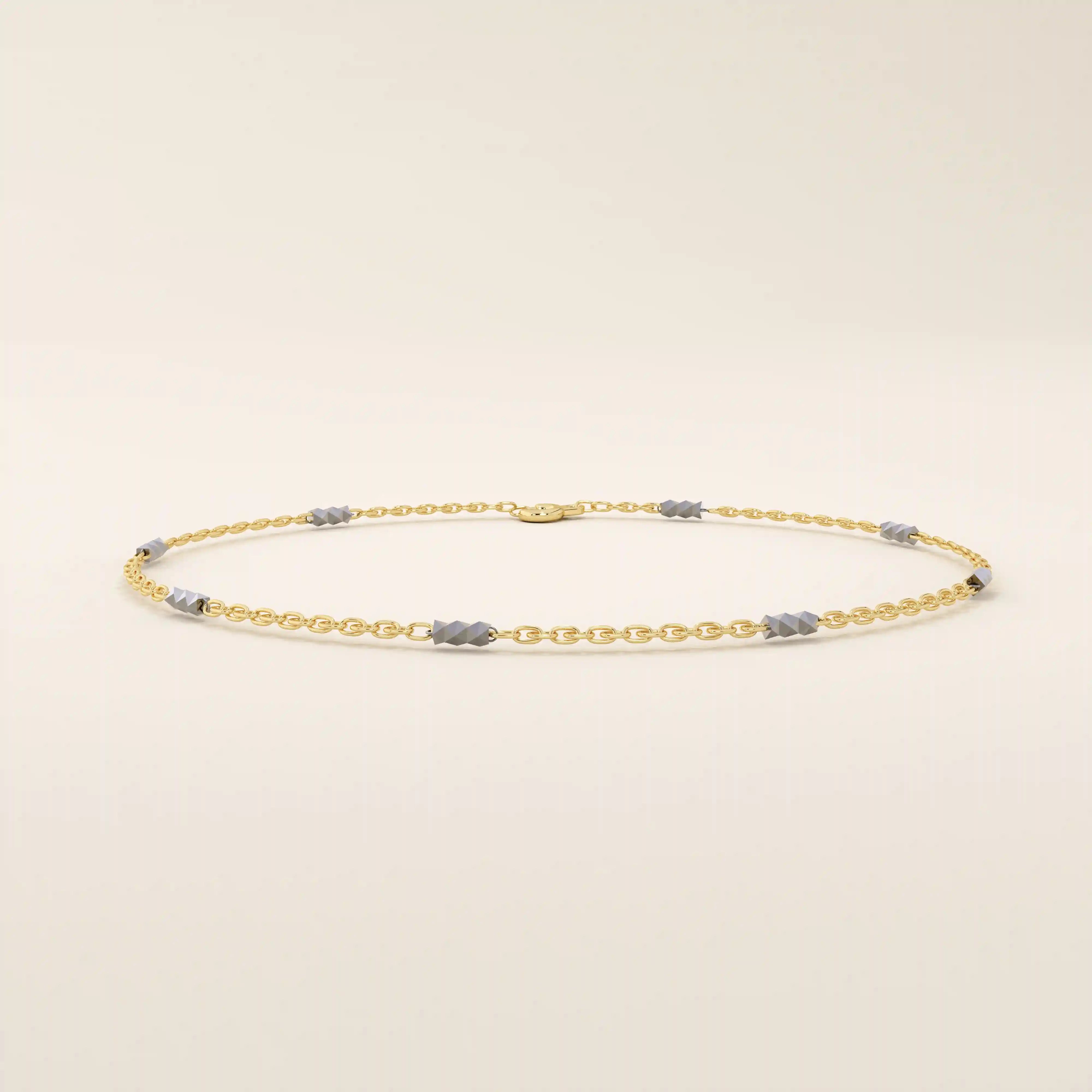 14k yellow gold bracelet with polished oval links and faceted white gold bar accents for a modern contrast.
