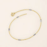 14k yellow gold bracelet with polished oval links and faceted white gold bar accents for a modern contrast.
