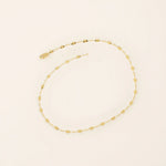 14k yellow gold bracelet with textured circular links featuring a starburst pattern.
