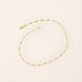 14k yellow gold bracelet with textured circular links featuring a starburst pattern.
