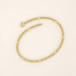 14k yellow gold bracelet with unique flat curb chain links accented by polished round discs.
