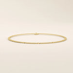14k yellow gold bracelet with unique flat curb chain links accented by polished round discs.
