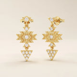 14k yellow gold dangling motif stud earrings with geometric star and triangle shapes, accented with moissanite stones.
