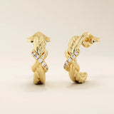 14k yellow gold knot stud earrings featuring twisted rope and smooth gold strands intertwined with a row of round moissanites.
