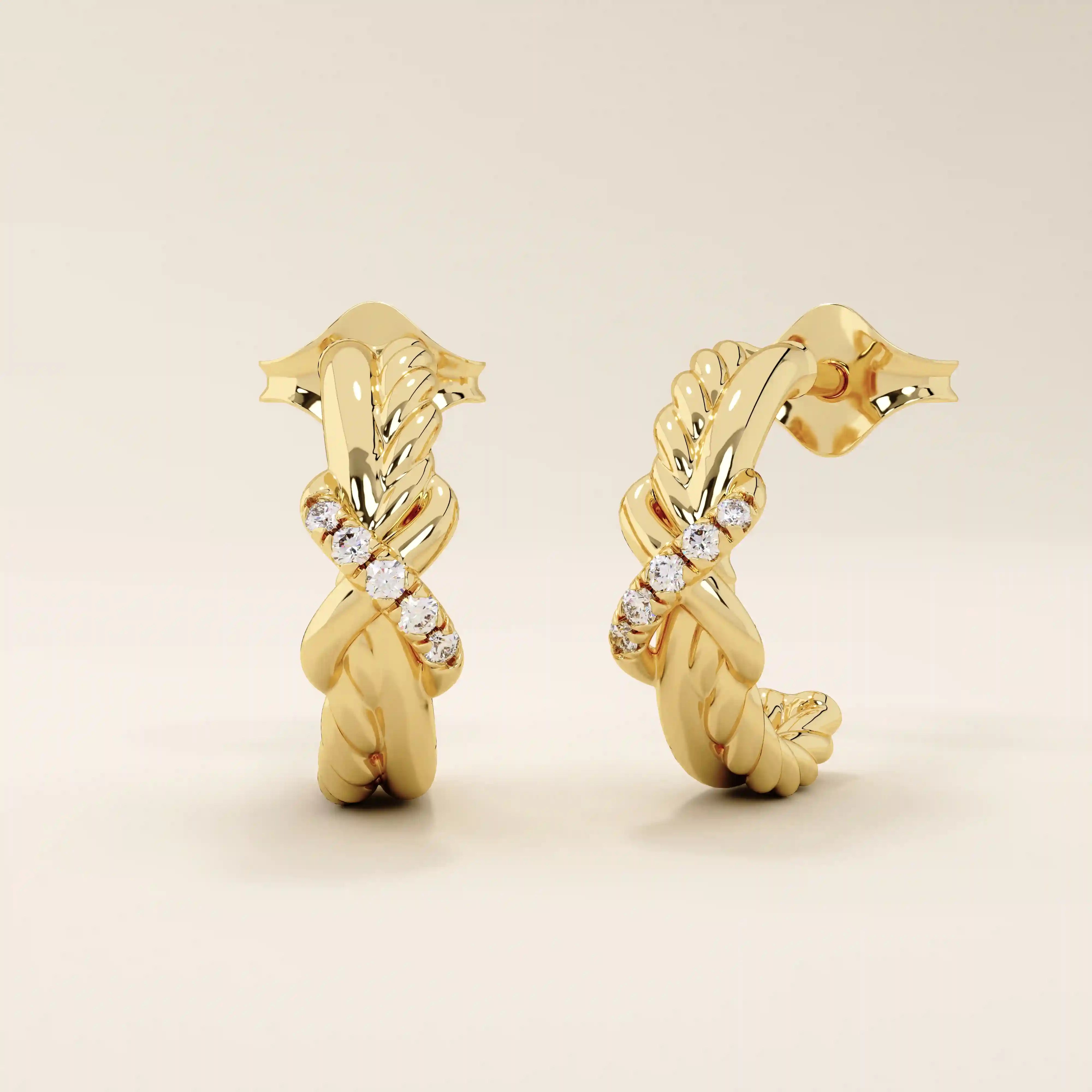14k yellow gold knot stud earrings featuring twisted rope and smooth gold strands intertwined with a row of round moissanites.
