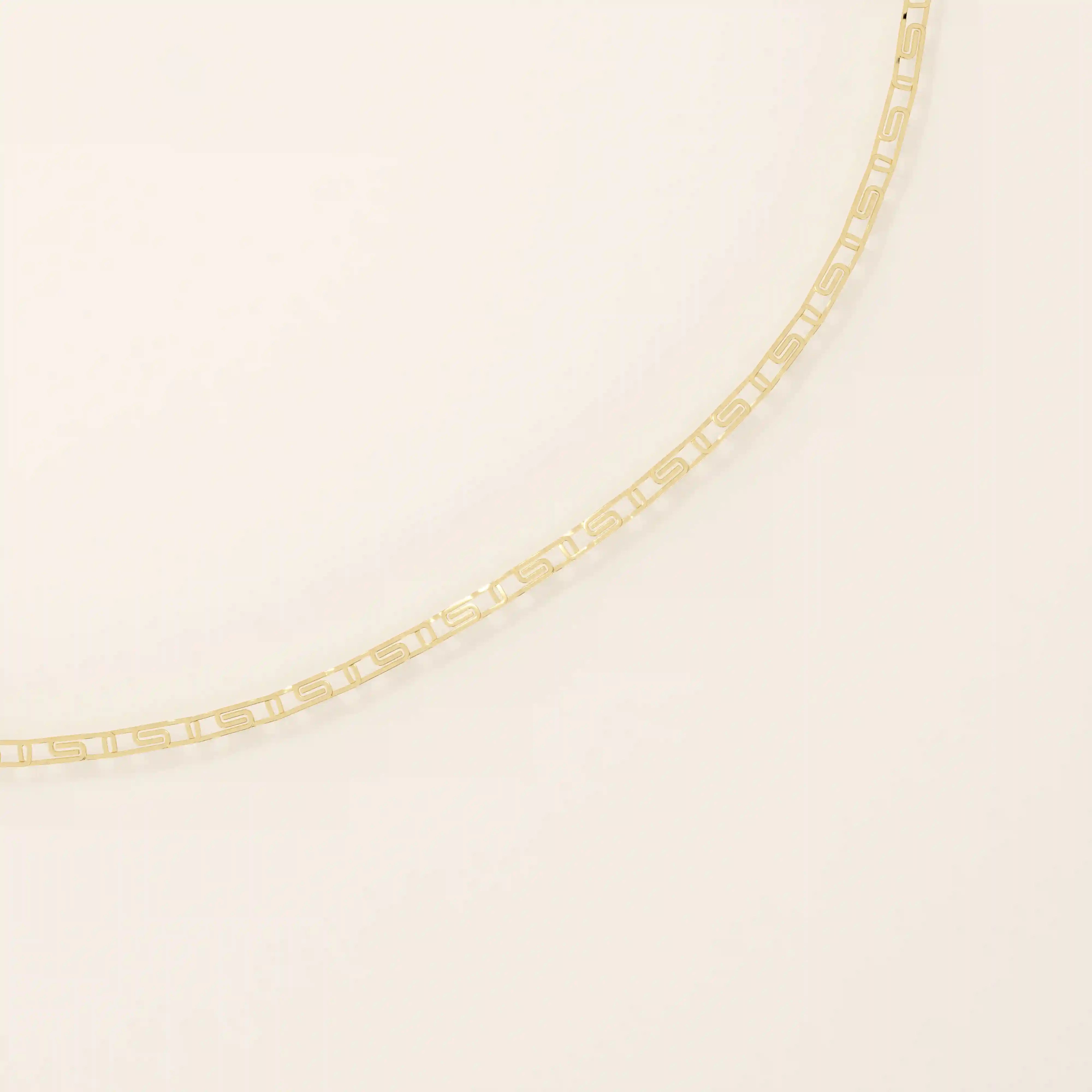 14k yellow gold scroll chain bracelet with rectangular links featuring an intricate cut-out scroll pattern.
