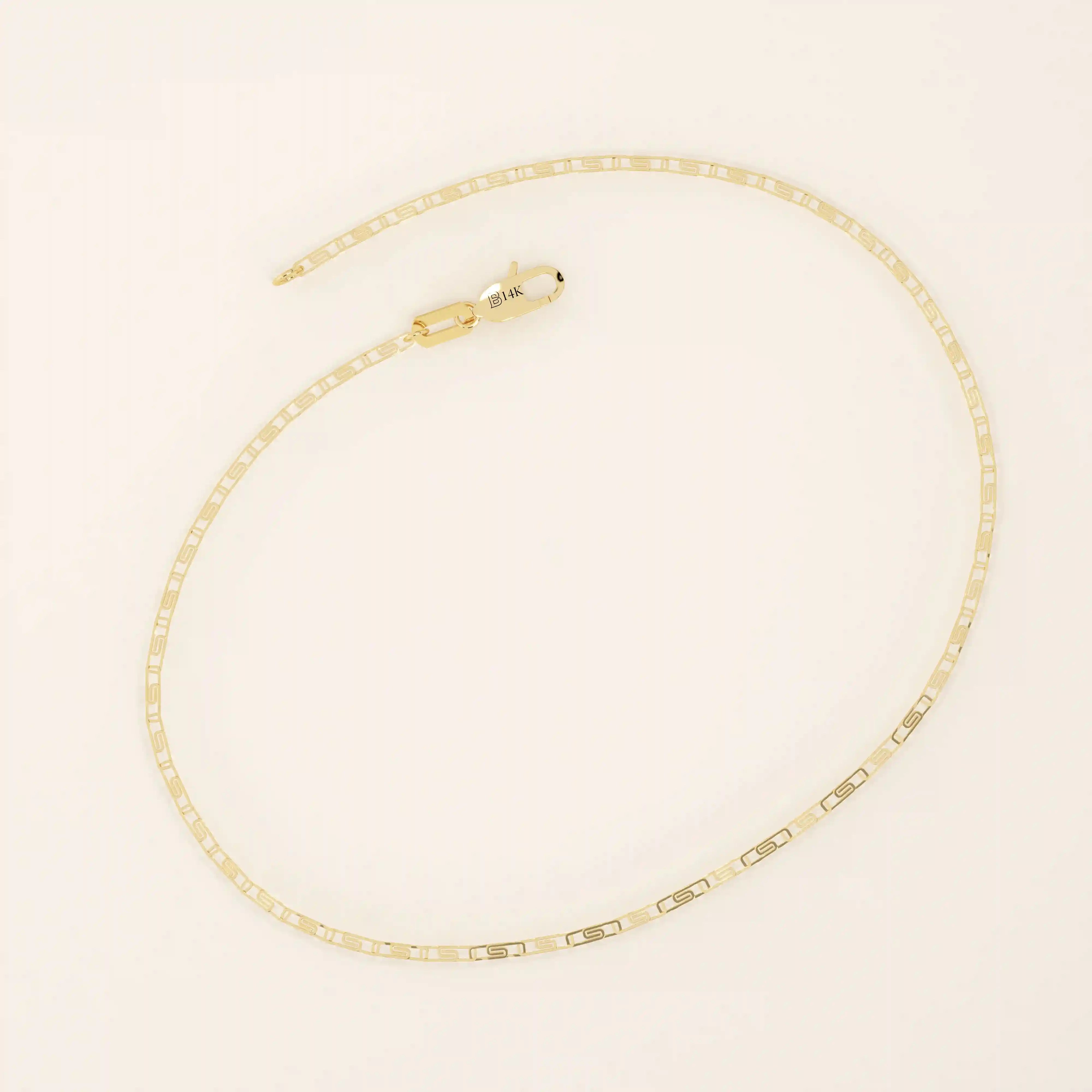14k yellow gold scroll chain bracelet with rectangular links featuring an intricate cut-out scroll pattern.
