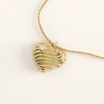 14k gold vermeil 3D heart necklace featuring a sculpted, wavy heart pendant accented with a single sparkling cubic zirconia for a romantic modern touch.
