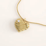 14k gold vermeil 3D heart necklace featuring a sculpted, wavy heart pendant accented with a single sparkling cubic zirconia for a romantic modern touch.
