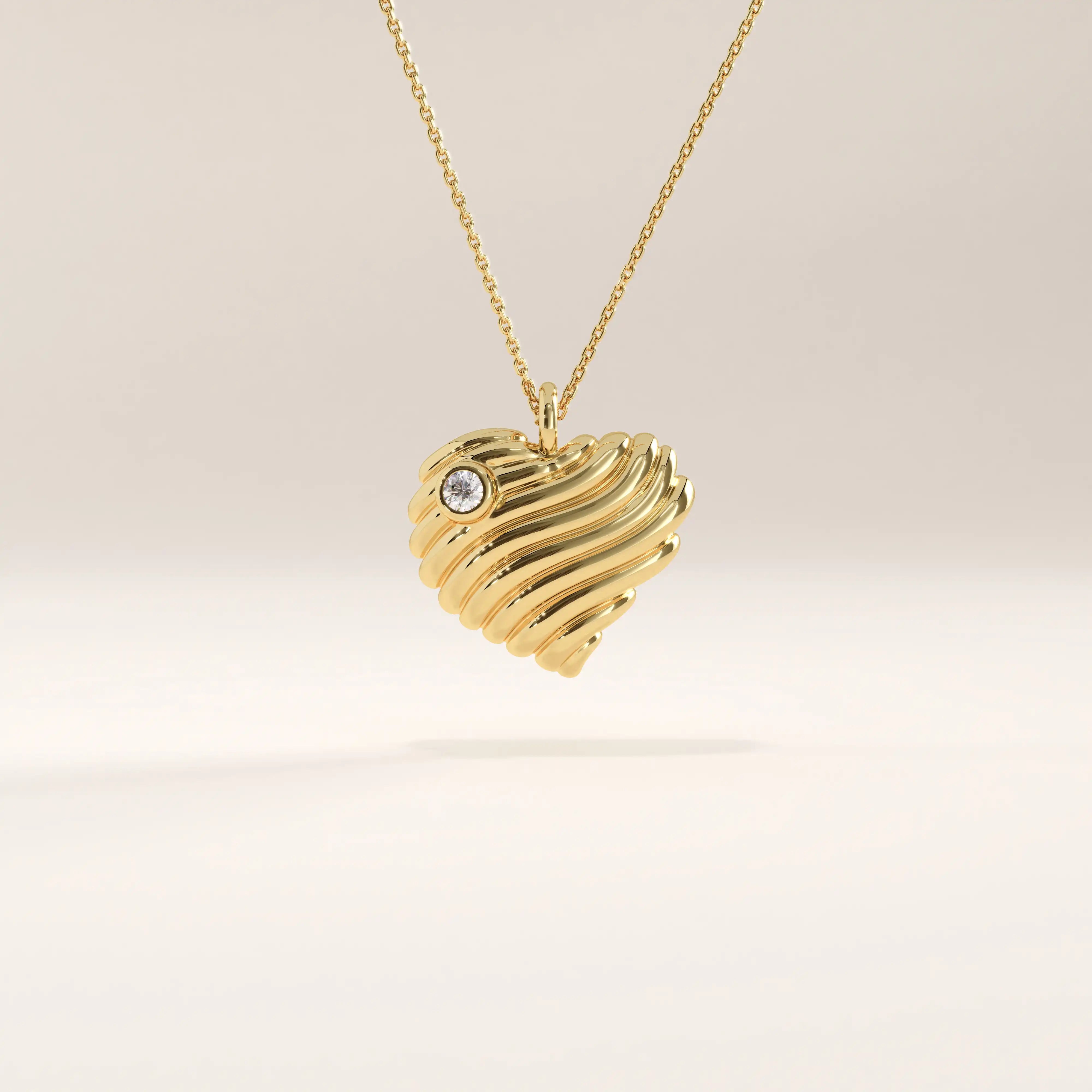 14k gold vermeil 3D heart necklace featuring a sculpted, wavy heart pendant accented with a single sparkling cubic zirconia for a romantic modern touch.
