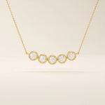5 stone bezel necklace in 14k yellow gold featuring five round brilliant stones set in a horizontal row on a delicate chain.
