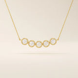 5 stone bezel necklace in 14k yellow gold featuring five round brilliant stones set in a horizontal row on a delicate chain.
