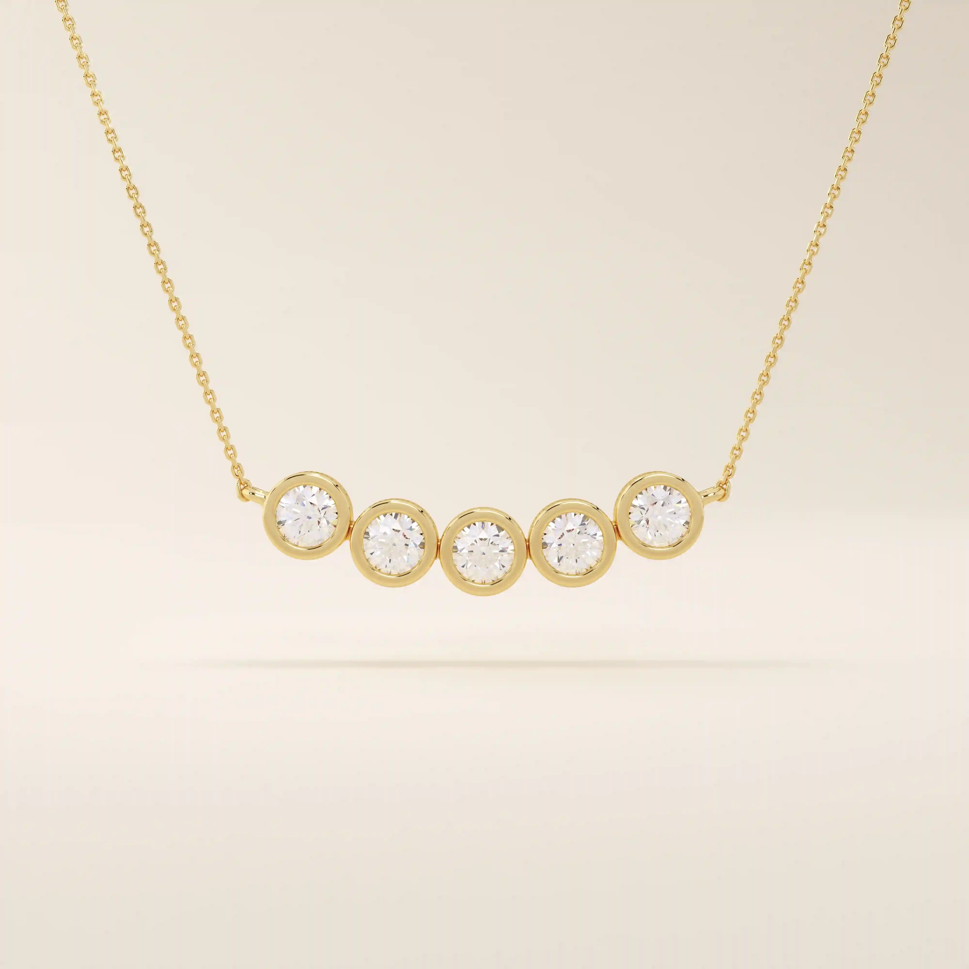 5 stone bezel necklace in 14k yellow gold featuring five round brilliant stones set in a horizontal row on a delicate chain.
