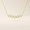 5 stone bezel necklace in 14k yellow gold featuring five round brilliant stones set in a horizontal row on a delicate chain.
