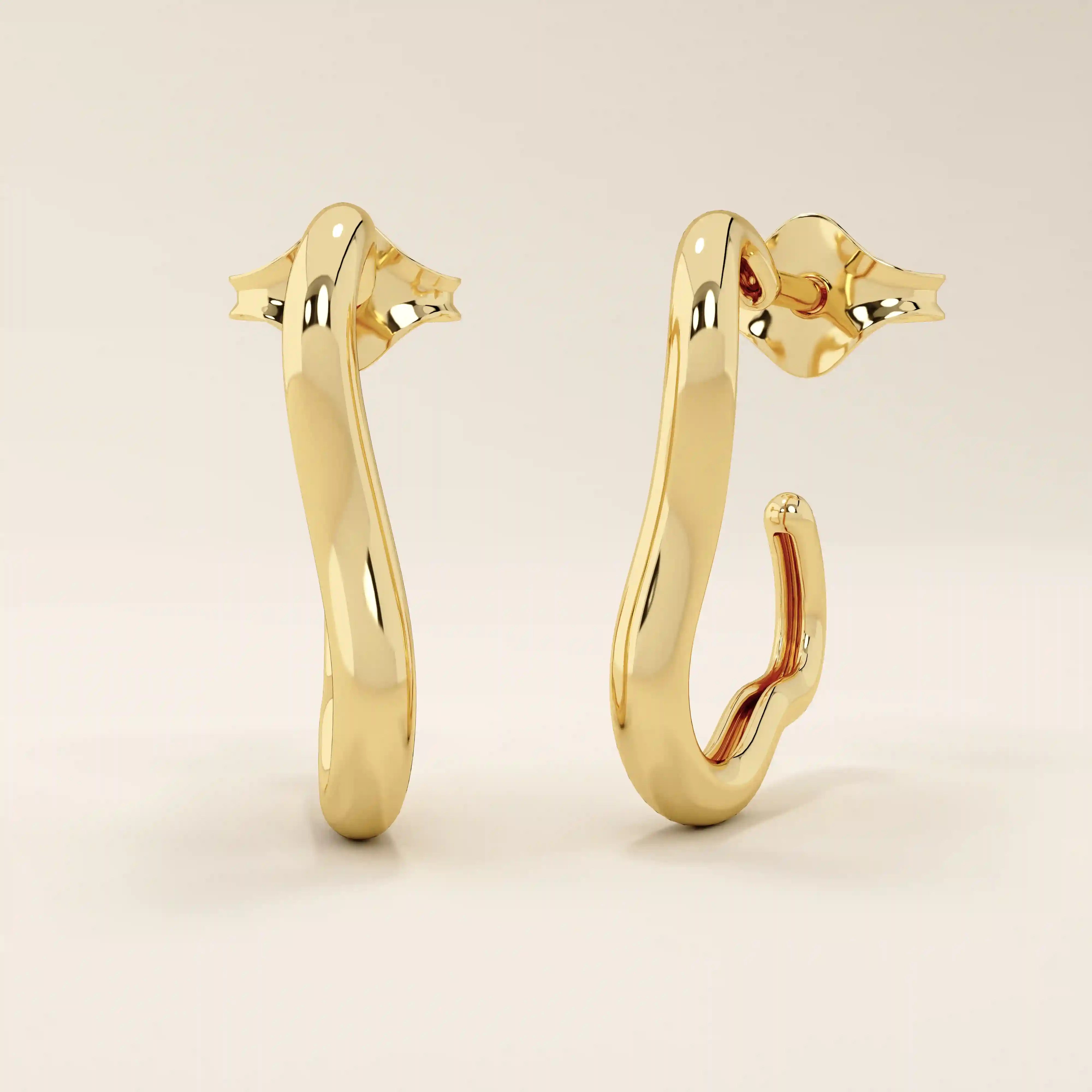 Angled view of 14k solid yellow gold abstract-shaped hoop studs showcasing their fluid silhouette and mirror-like polish.
