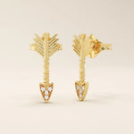 Angled view of 14k solid yellow gold arrow studs, highlighting the dimensional fletching design and the moissanite-studded arrow tip.
