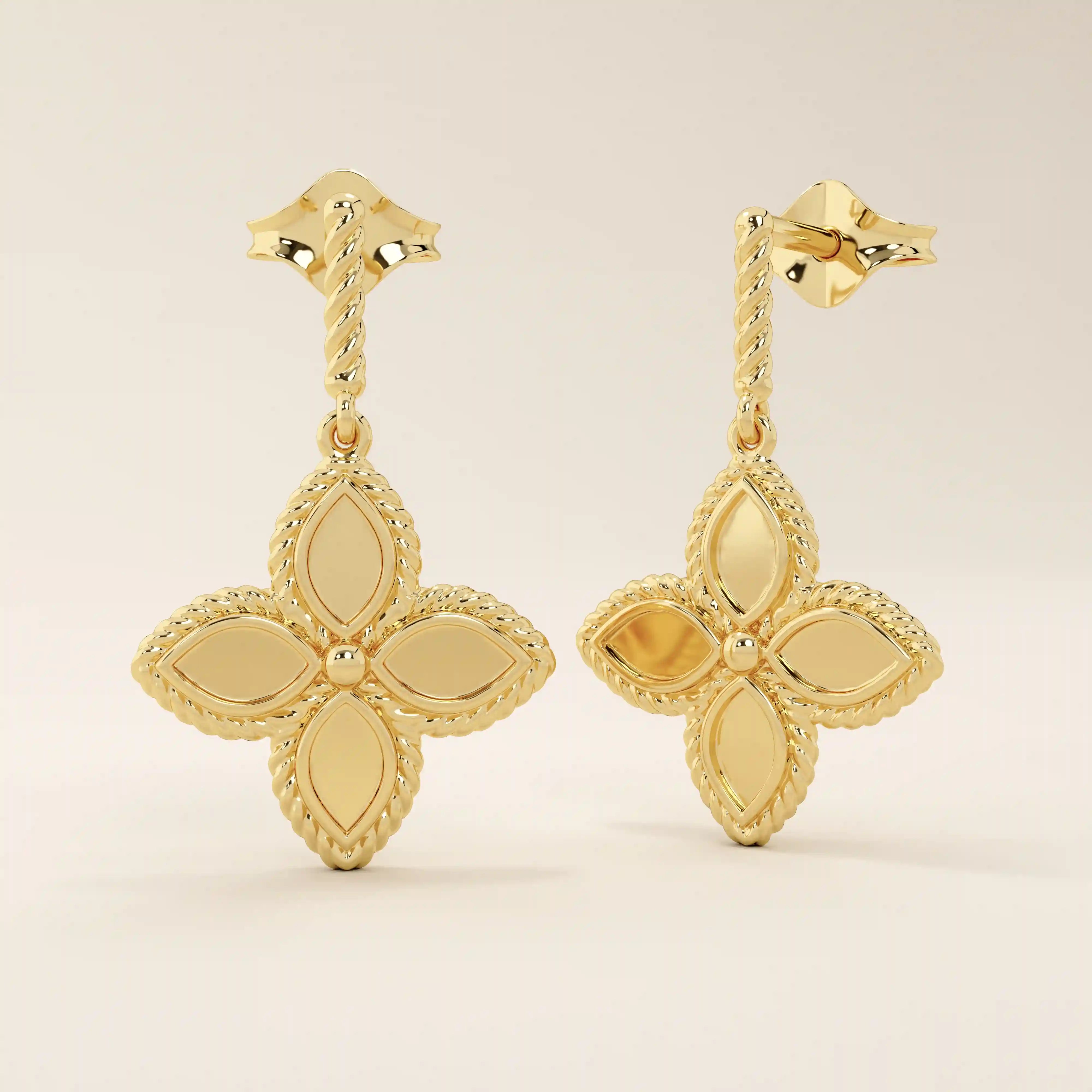 Angled view of 14k solid yellow gold dangle clover studs, highlighting the twisted post and intricate beaded border on each petal.
