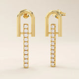 Angled view of 14k solid yellow gold dangling bar stud earrings with a polished U-frame and vertical row of moissanite stones.
