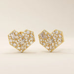 Angled view of 14k solid yellow gold heart studs, showing the intricate mix of baguette and round white moissanite stones for depth and shimmer.

