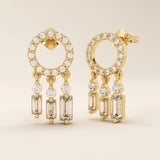 Angled view of 14k yellow gold pavé circle stud earrings with three moissanite drop dangles in mixed shapes.
