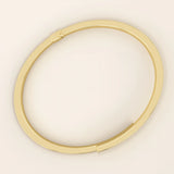 Angled view of a 14k yellow gold wrap-around bracelet highlighting its overlapping band design and smooth curvature.
