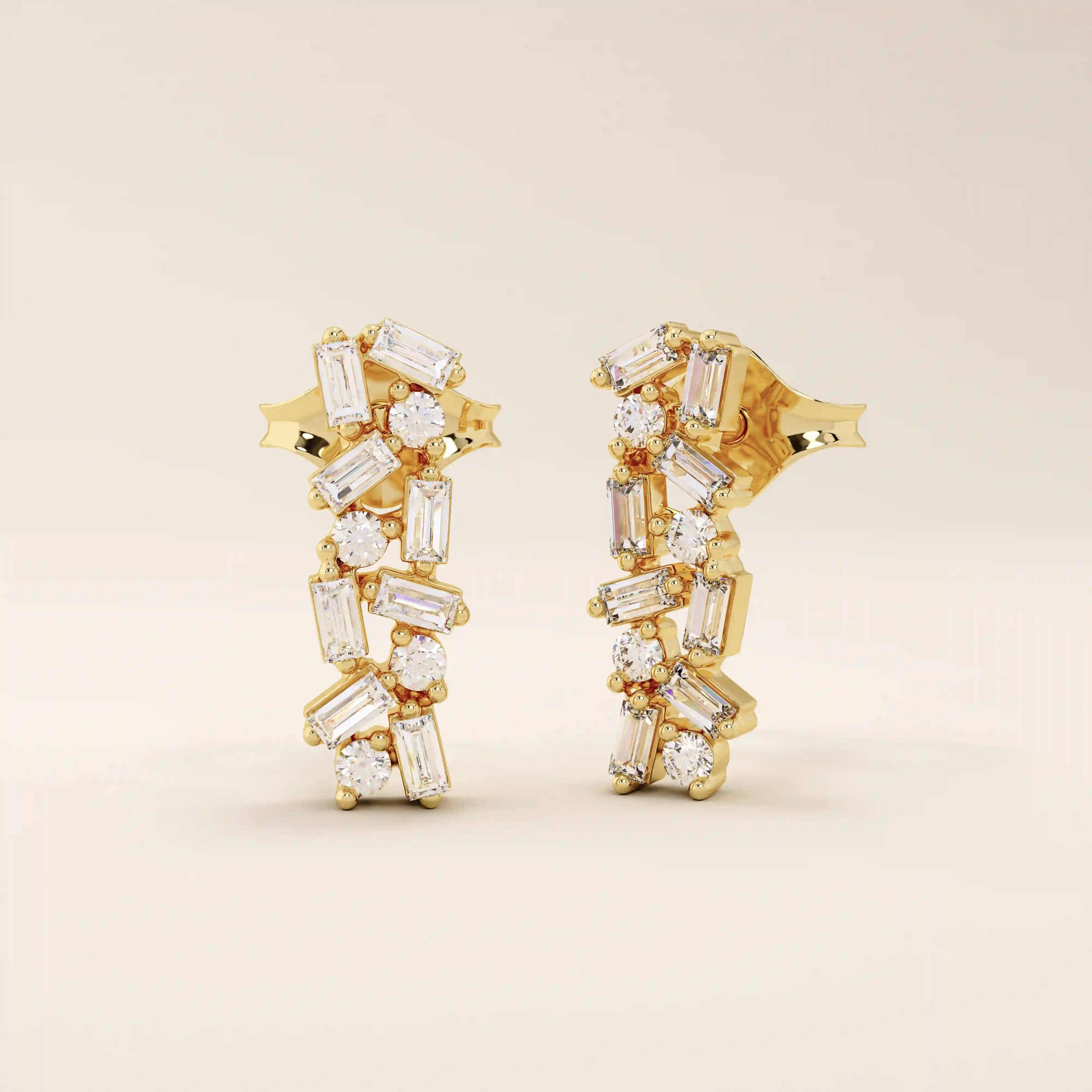 Baguette cluster stud earrings in 14k yellow gold featuring a mix of baguette and round stones in a scattered design.
