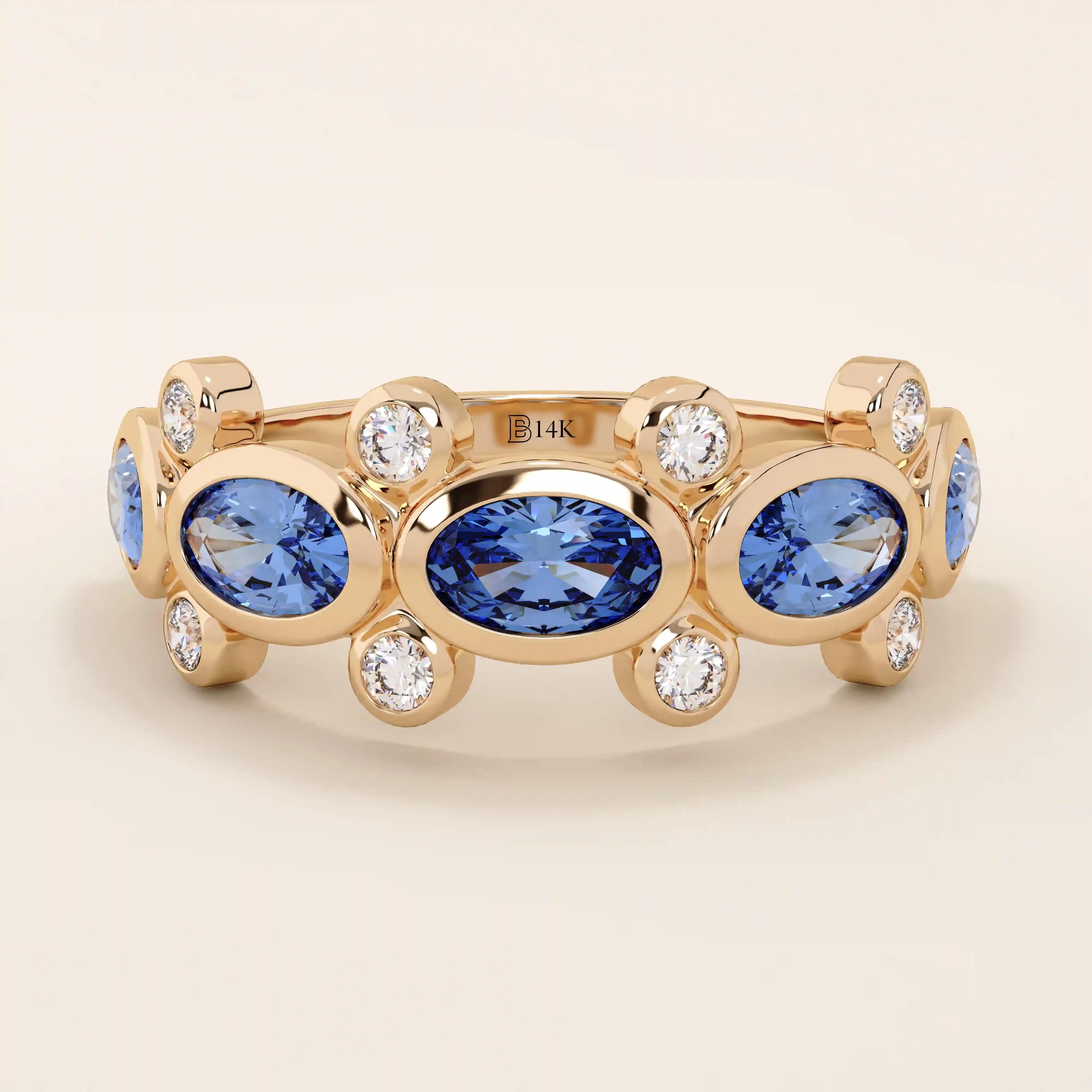 Bold gold ring with five bezel set oval sapphire gemstones. A striking statement ring with a unique symmetrical design.