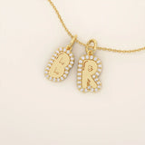 Bubble font initial pendant in 14k solid gold, framed with a halo of shimmering moissanites. A bold yet playful personalized necklace.