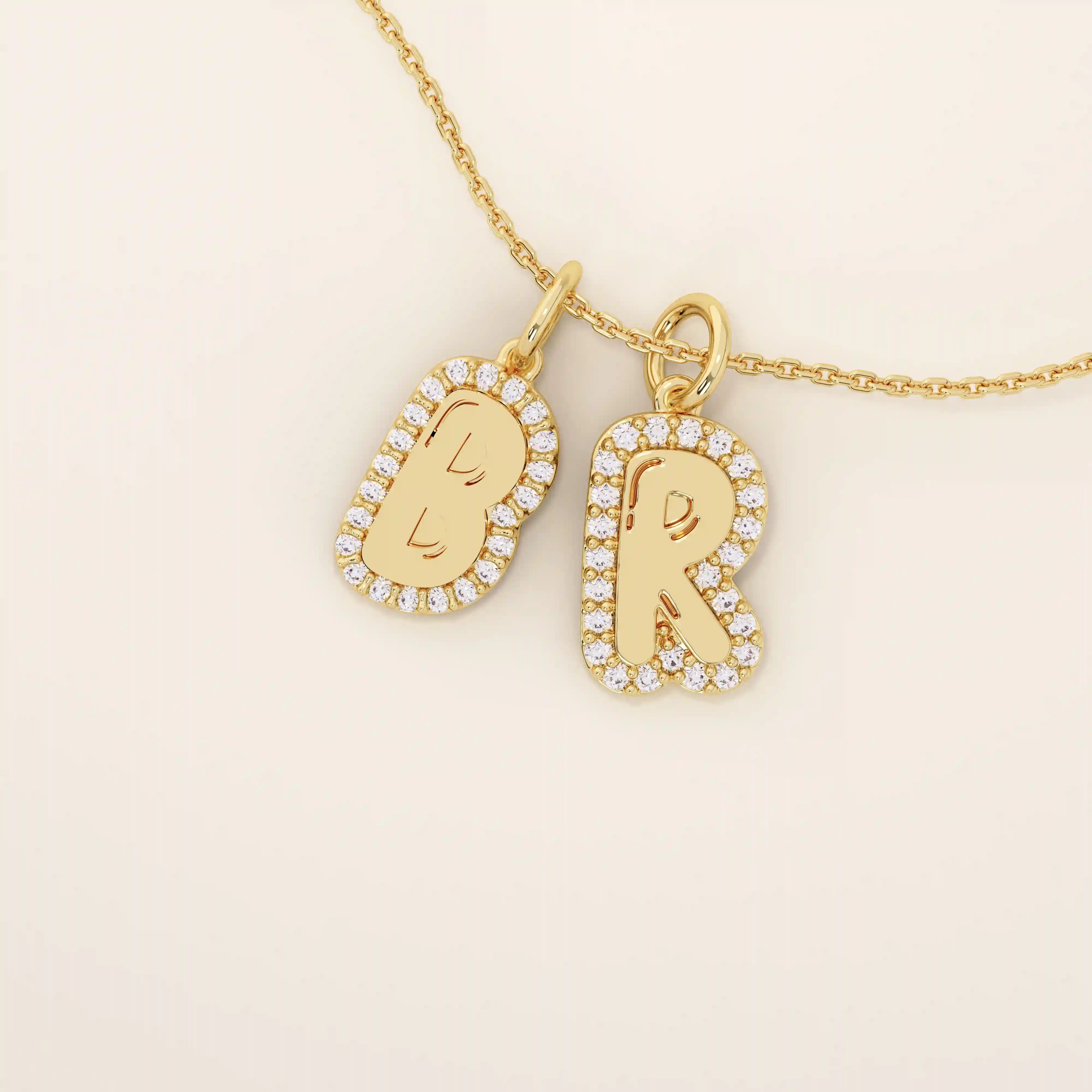 Bubble font initial pendant in 14k solid gold, framed with a halo of shimmering moissanites. A bold yet playful personalized necklace.