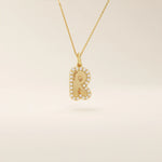 Bubble font initial pendant in 14k solid gold, framed with a halo of shimmering moissanites. A bold yet playful personalized necklace.