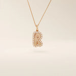 Bubble font initial pendant in 14k solid gold, framed with a halo of shimmering moissanites. A bold yet playful personalized necklace.