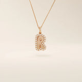 Bubble font initial pendant in 14k solid gold, framed with a halo of shimmering moissanites. A bold yet playful personalized necklace.