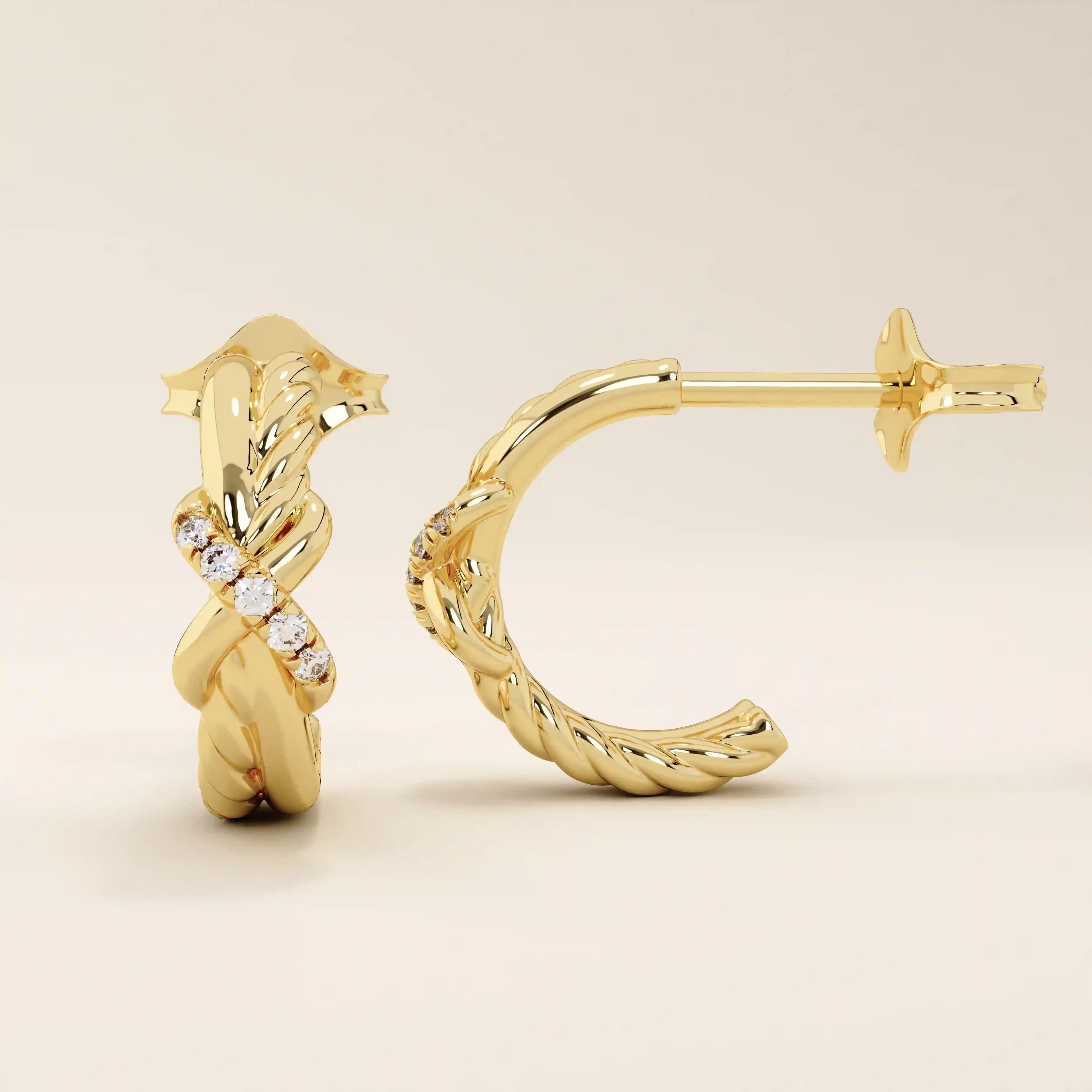 Close-up of 14k gold knot stud earrings highlighting the twisted rope design and moissanite accents.
