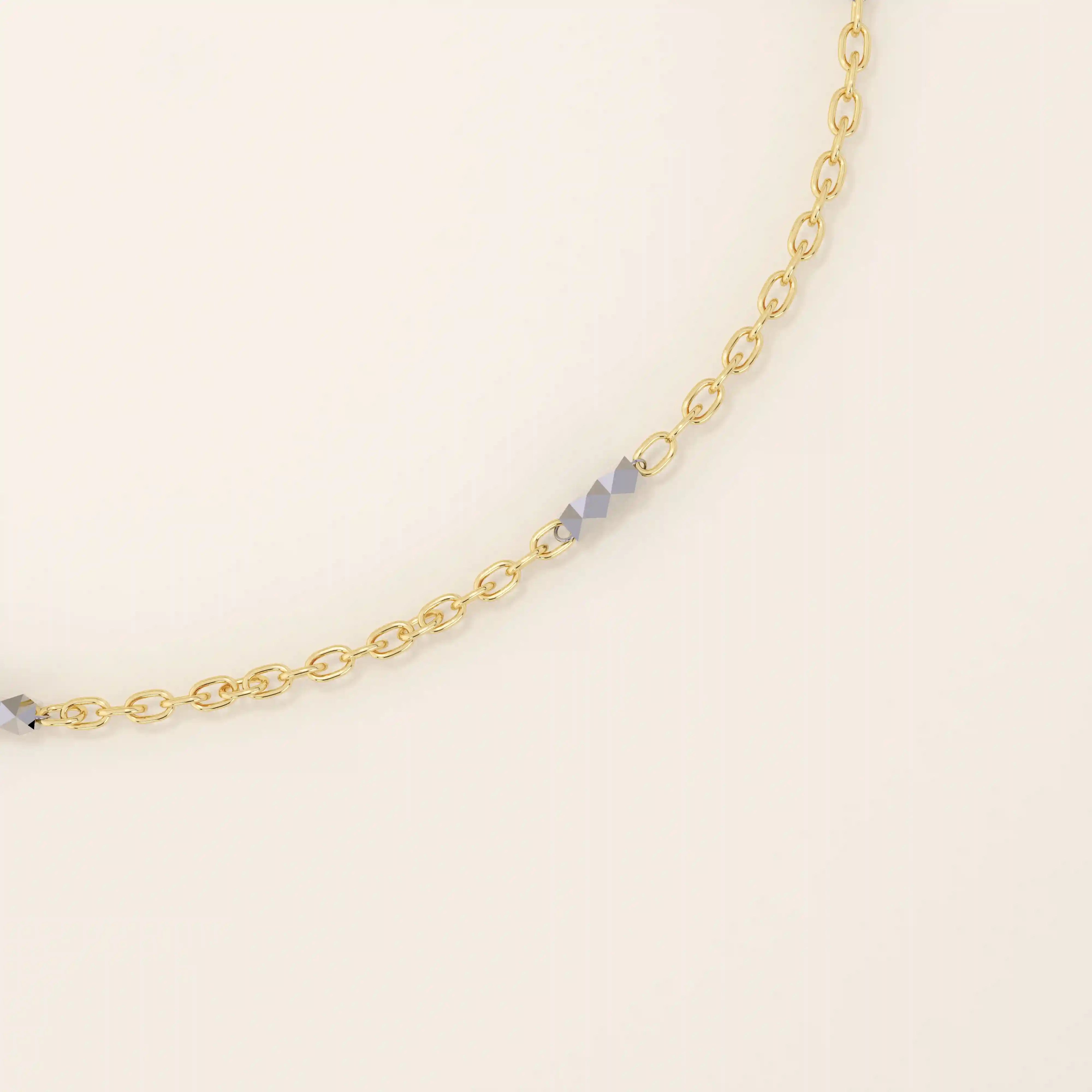 Close-up of a 14k gold bracelet with oval chain links and faceted mixed-metal bar accents for added shine.
