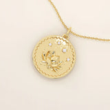 Close-up of a 14k solid gold pendant necklace featuring an embossed water lily and a tiny moissanite. Dainty nature-inspired jewelry for women. Ideal as a minimalist everyday gold necklace.