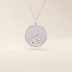 Close-up of a 14k solid white gold pendant necklace featuring an embossed water lily and a tiny moissanite. Dainty nature-inspired jewelry for women. Ideal as a minimalist everyday gold necklace.