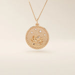 Close-up of a 14k solid rose gold pendant necklace featuring an embossed water lily and a tiny moissanite. Dainty nature-inspired jewelry for women. Ideal as a minimalist everyday gold necklace.