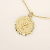 Close-up of a 14k solid gold pendant necklace with an embossed single rose and tiny moissanites. Romantic floral gold necklace for women. Perfect minimalist jewelry gift.