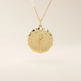Close-up of a 14k solid gold pendant necklace with an embossed single rose and tiny moissanites. Romantic floral gold necklace for women. Perfect minimalist jewelry gift.