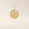 Close-up of a 14k solid gold pendant necklace with an embossed single rose and tiny moissanites. Romantic floral gold necklace for women. Perfect minimalist jewelry gift.