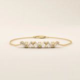 Close-up of a 14k yellow gold baguette bar bracelet highlighting the alternating baguette-cut stones and round stones.
