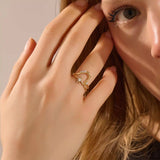 Close-up of a model’s hand wearing a 14k yellow gold starburst ring with moissanite center and accent stones.
