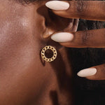Close-up of a model wearing a 14k solid yellow gold round curb chain stud earring, highlighting its bold circular form and lustrous links.
