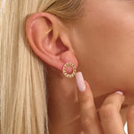 Close-up of a model wearing a 14k solid yellow gold round curb chain stud earring, highlighting its bold circular form and lustrous links.
