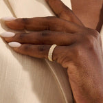 Close-up of a woman wearing a 14k solid yellow gold dome band with rows of pavé set round brilliant cut moissanite stones, luxurious and elegant wedding or statement ring
 2