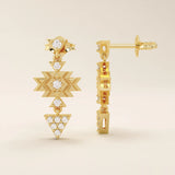 Close-up of dangling motif stud earrings in 14k gold with moissanite set in geometric star and triangle shapes.
