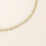 Close-up view of a 14k gold rolo chain bracelet showing the polished interlocking rectangular links.
