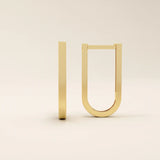 Close-up view of geometric U-shape hoop earrings in 14k gold with a smooth polished surface.
