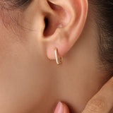 Model wearing 14k gold vermeil rectangle hoop earrings that highlight their clean, sculptural lines and lustrous golden sheen — ideal for modern everyday style.
