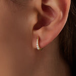 Model wearing 14k gold vermeil U shape hoop earrings that showcase their elegant curvature and radiant sparkle — perfect for both everyday wear and special occasions.
